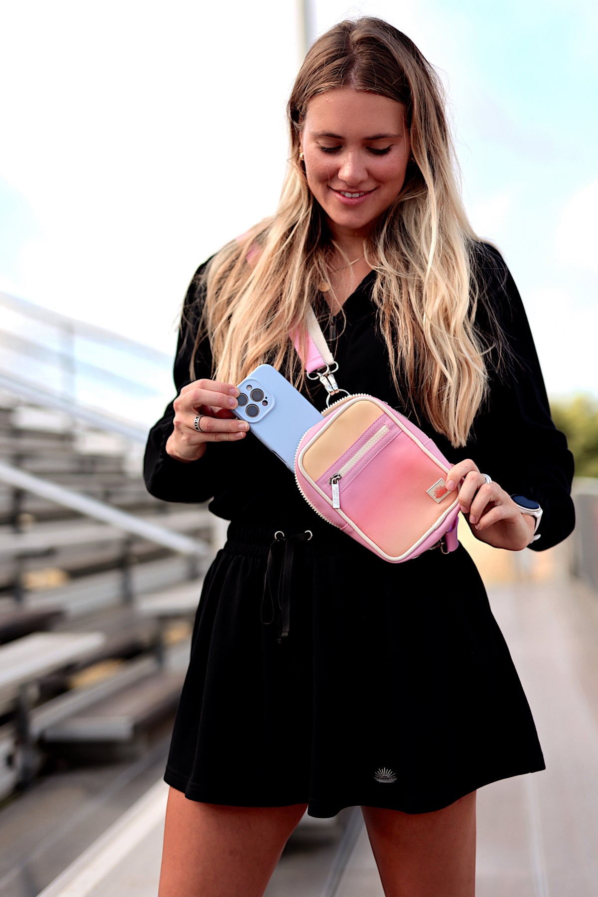 Stylish gradient pink and peach crossbody bag made of durable material, perfect for casual outings.