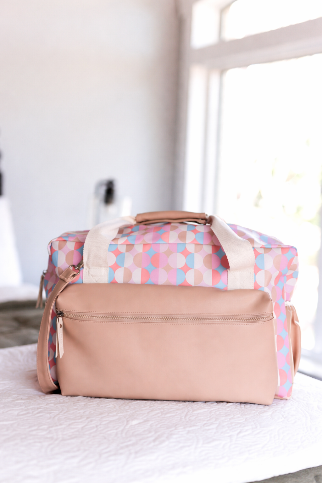 Tan and pink print duffle bag