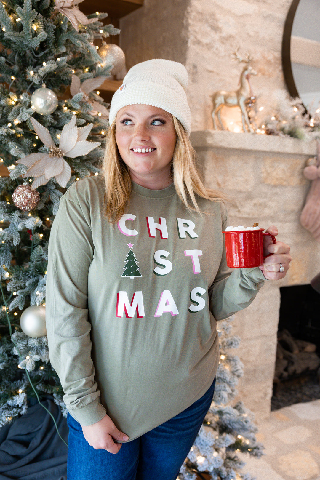 Cozy green long sleeve Christmas shirt with festive letters and tree design, perfect for holiday gatherings.
