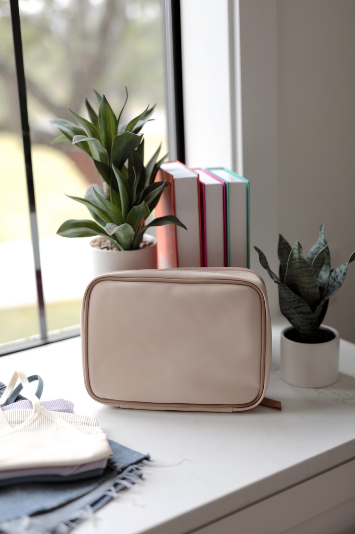 Stylish beige cosmetic pouch made of durable material, perfect for organizing beauty essentials.