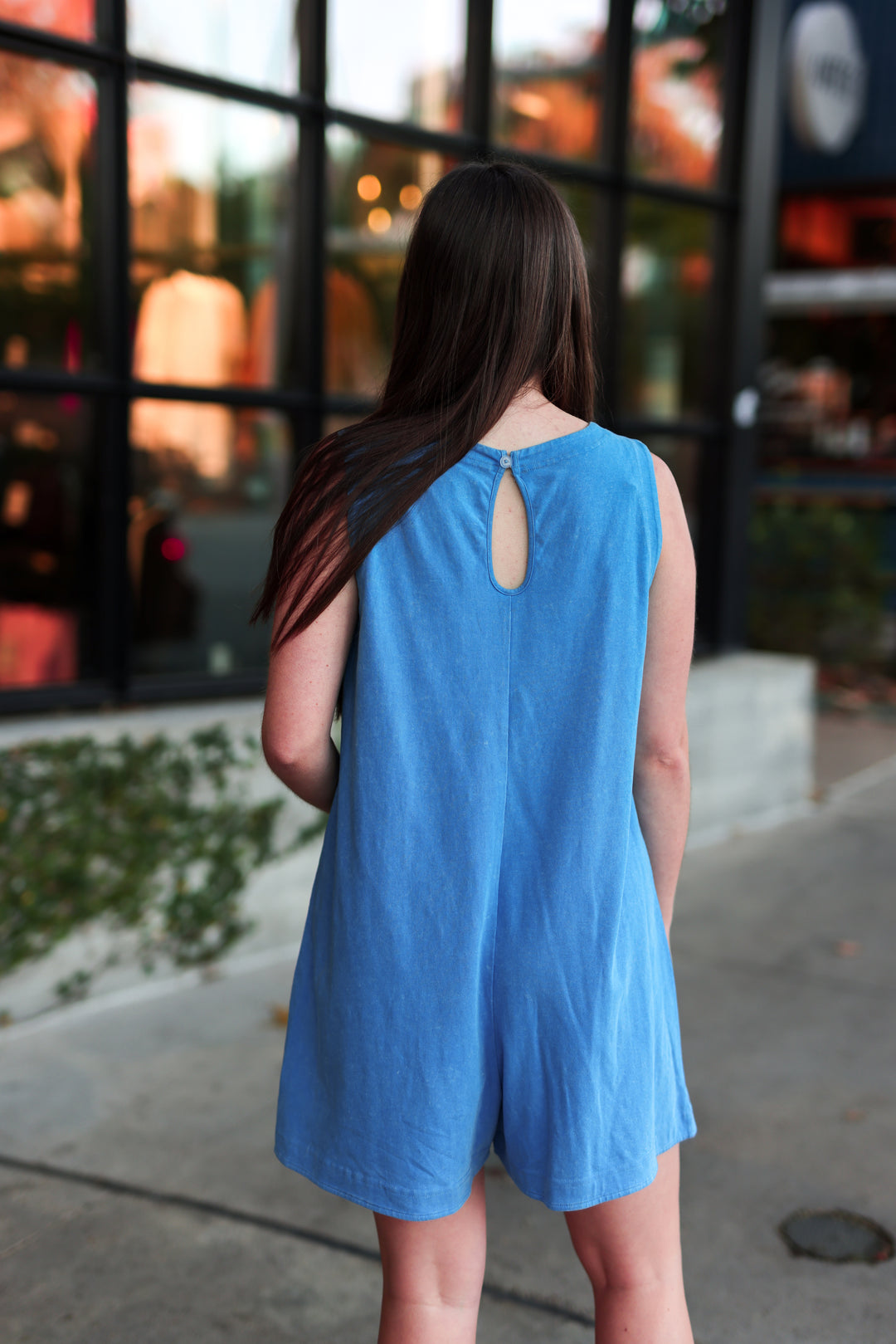 Blue sleeveless romper with a keyhole back detail, perfect for casual summer outings.