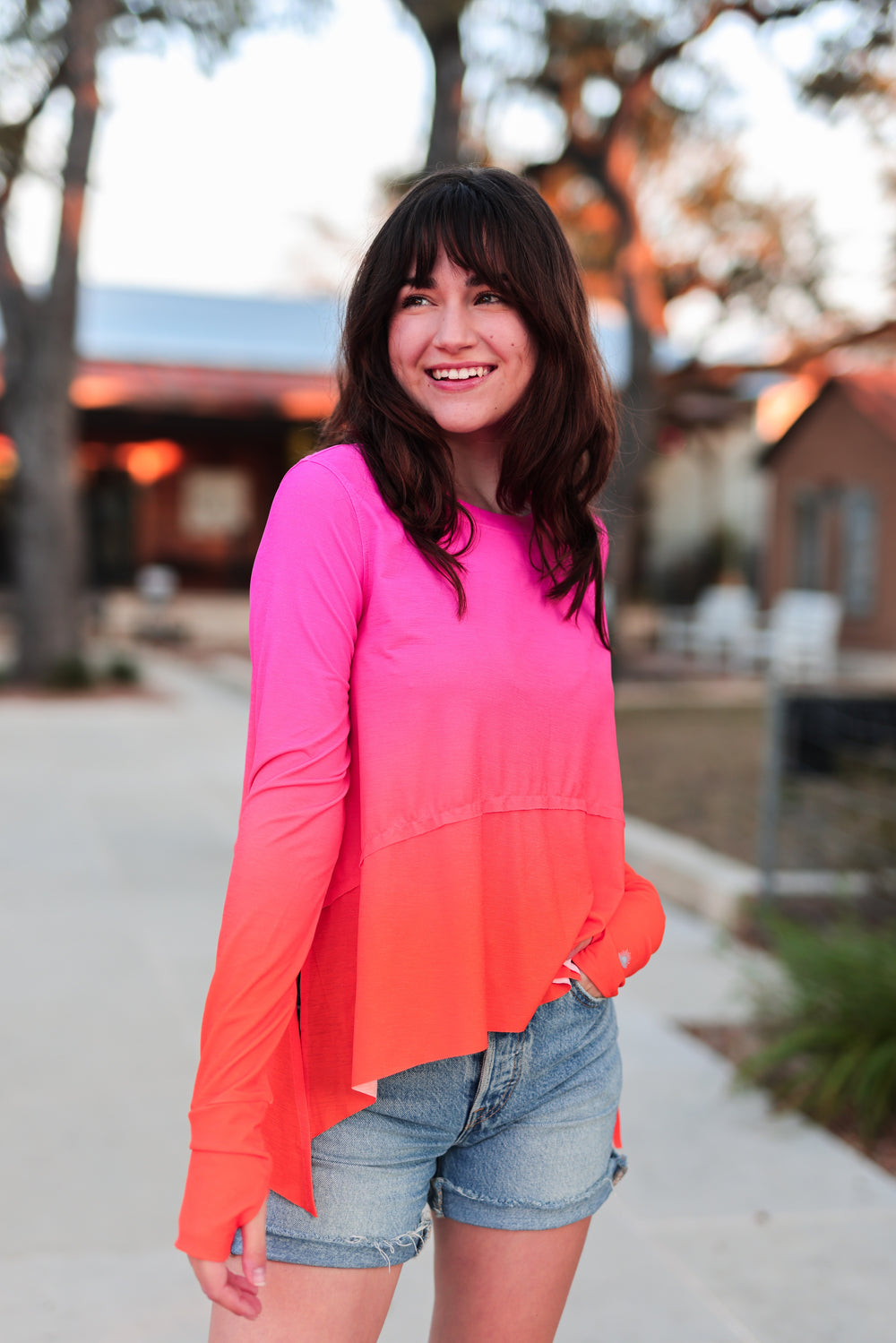Bright pink and orange ombre long-sleeve shirt in soft fabric, perfect for casual outings.