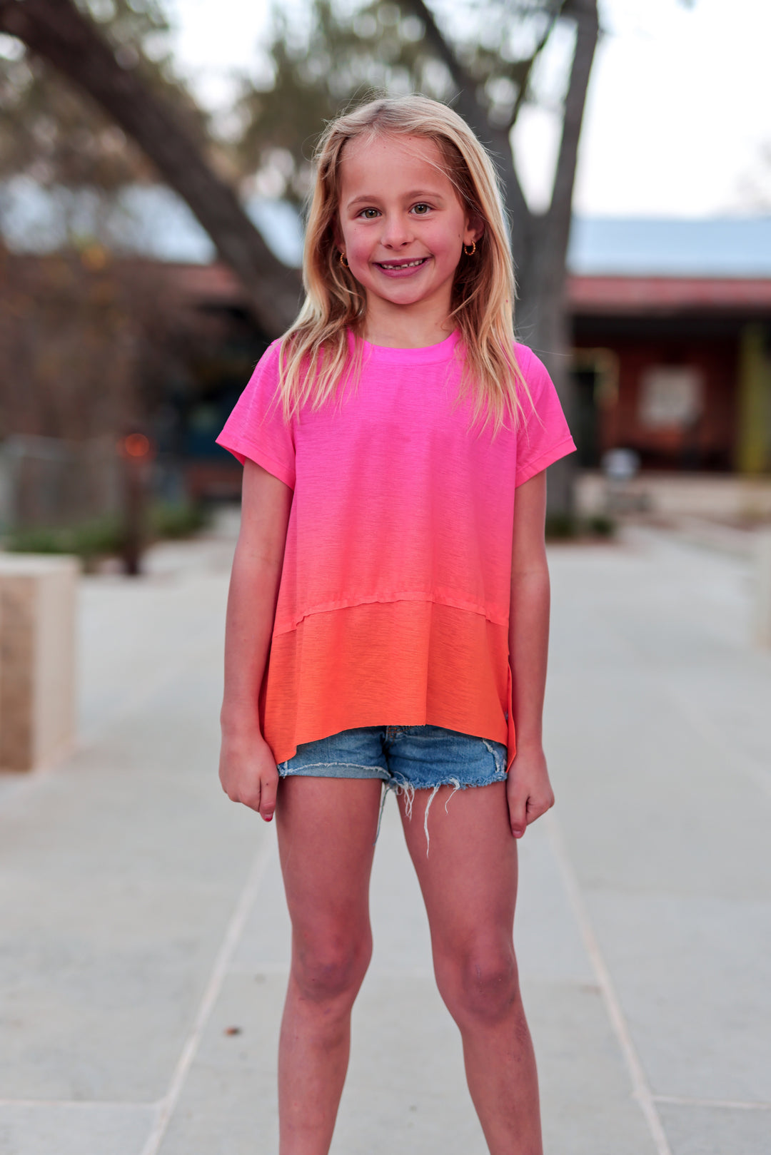 Girls' pink and orange ombre T-shirt, short sleeves, lightweight fabric, perfect for casual summer wear.