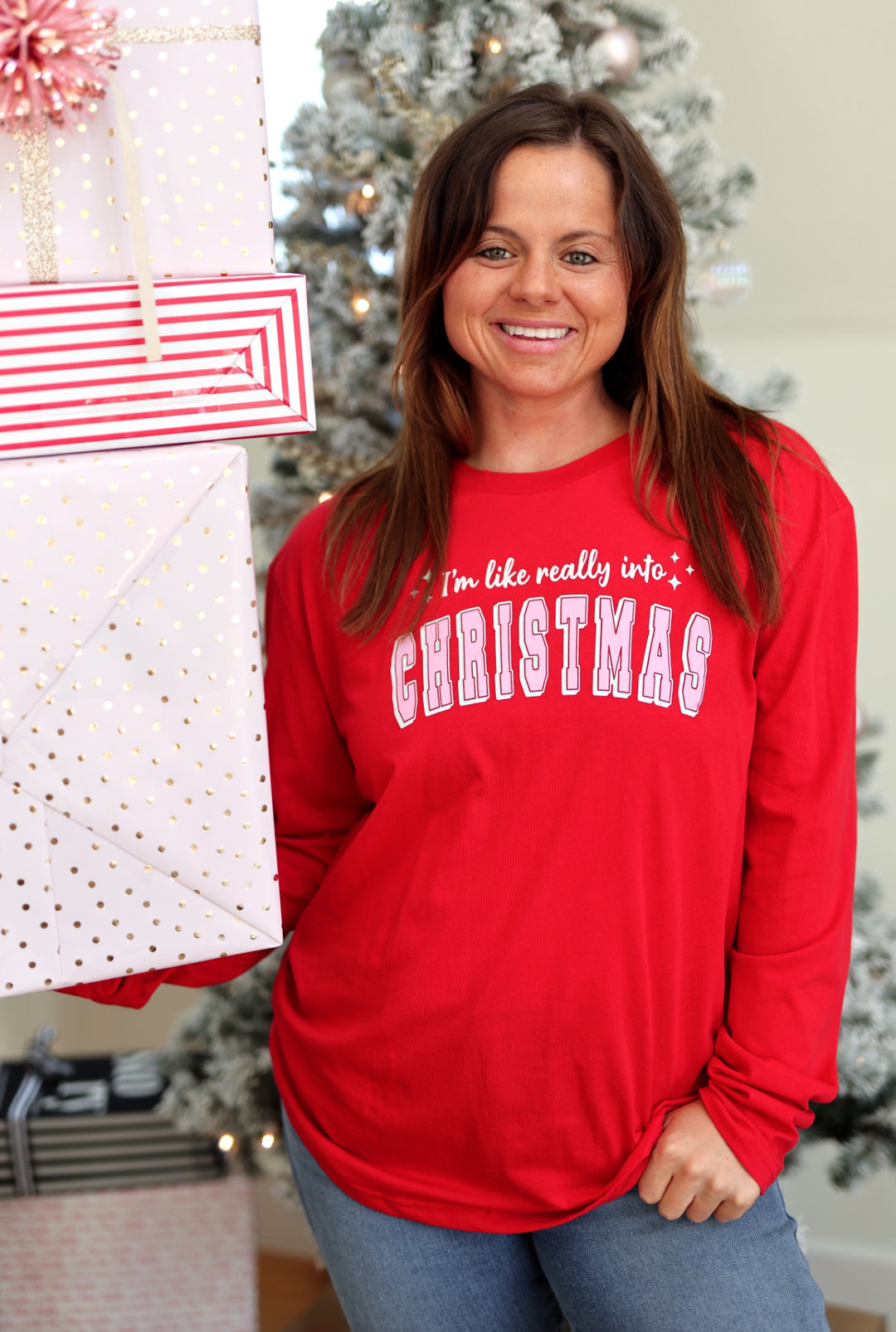 Women's long-sleeve red Christmas shirt with fun graphic design, perfect for holiday festivities.