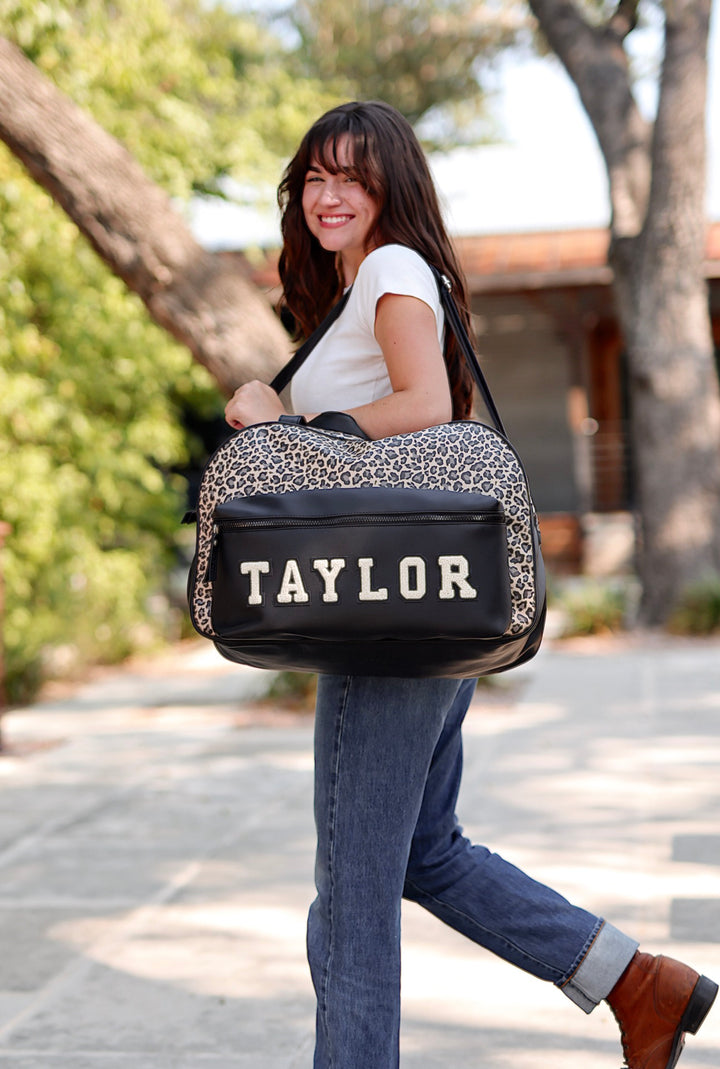 Stylish black and leopard print personalized duffel bag, perfect for travel, gym, or everyday use.