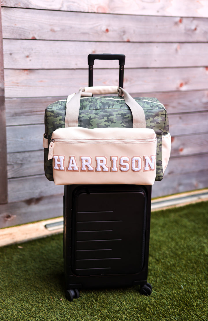 Camo duffel bag with personalized 'HARRISON' design on beige front, perfect for travel and stylish storage.