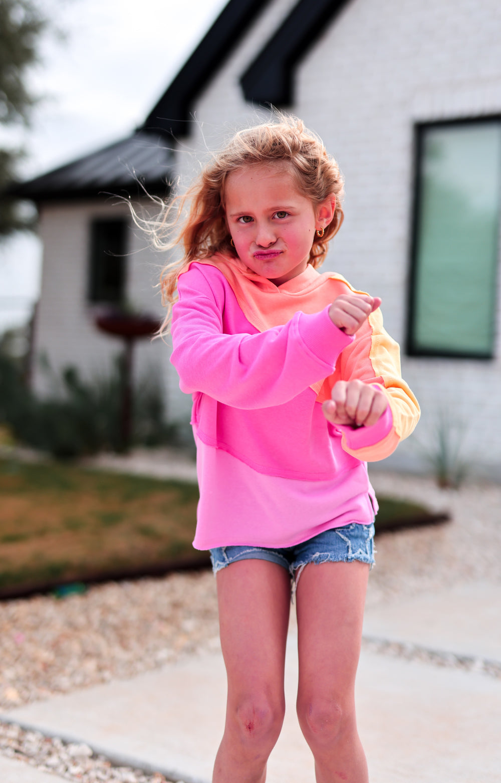 Colorful kids' hoodie, pink and orange, made from soft material, perfect for casual wear and active play.