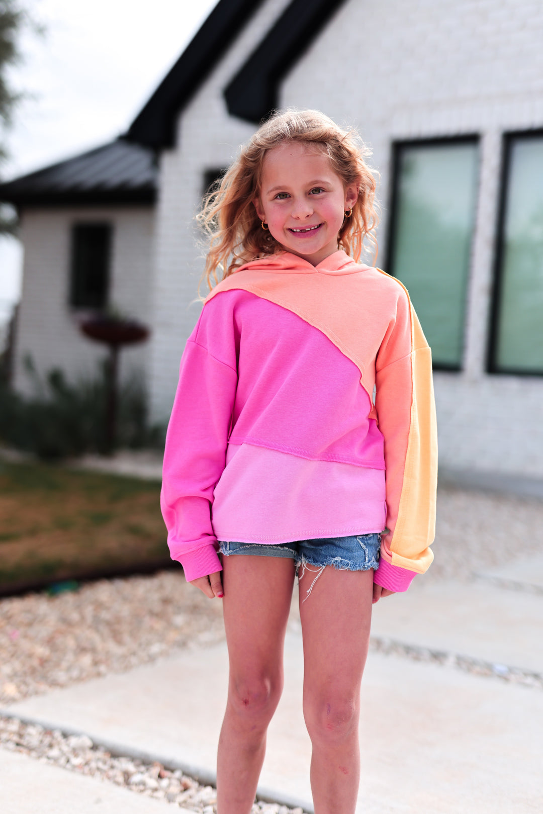 Colorful kids hoodie in pink and orange, made of soft cotton, perfect for casual wear.