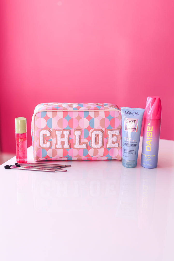 Personalized cosmetic bag with 'Chloe' on a pink background