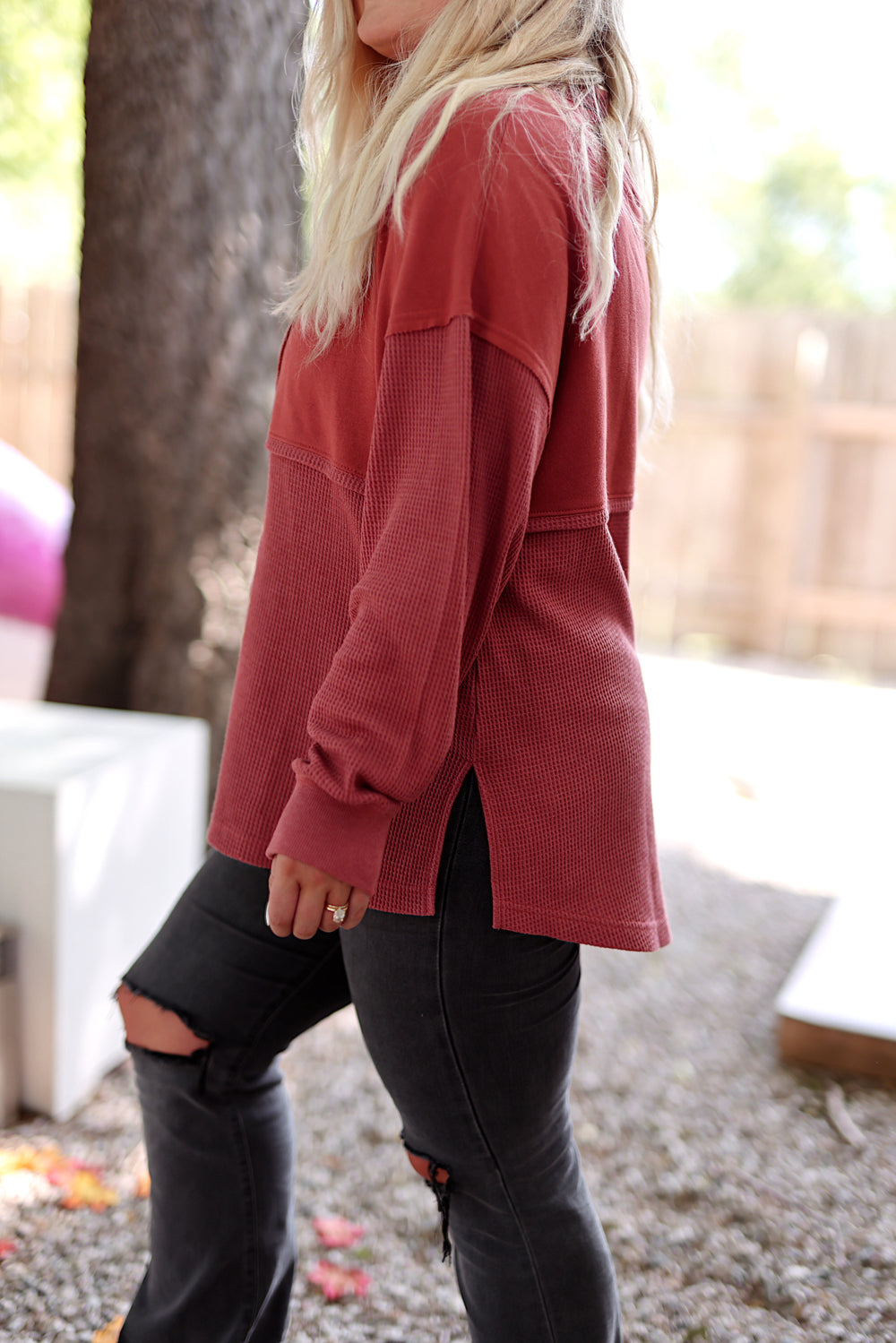 Women's maroon waffle knit top with side slits, perfect for casual wear and layering.