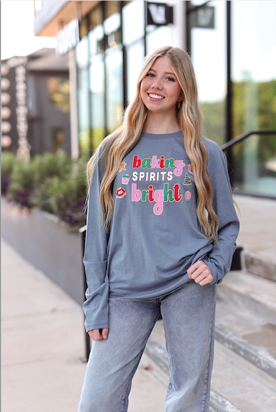 Gray long-sleeve t-shirt with 'baking spirits bright' text design, perfect for holiday baking enthusiasts.