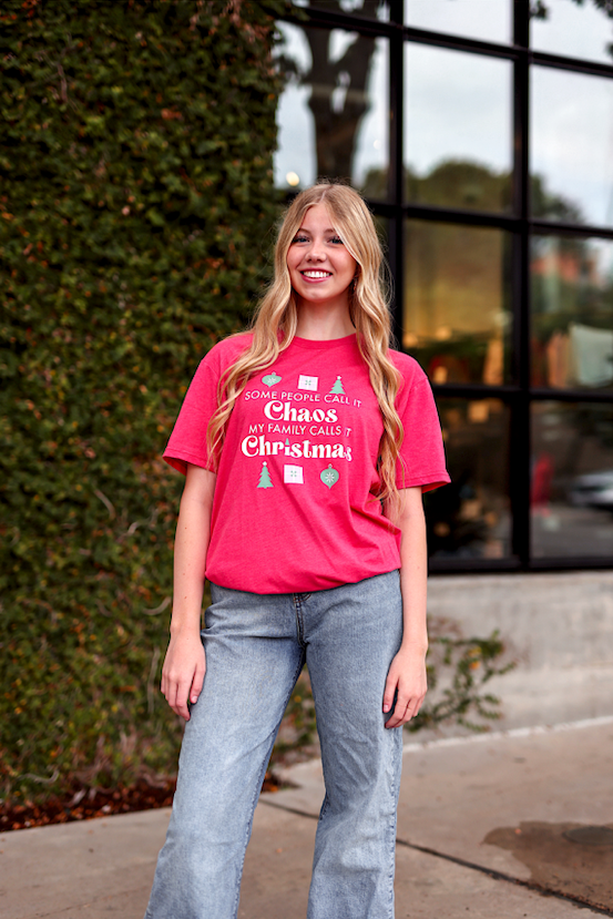 Bright pink Christmas graphic tee with fun text, ideal for festive gatherings and casual wear.