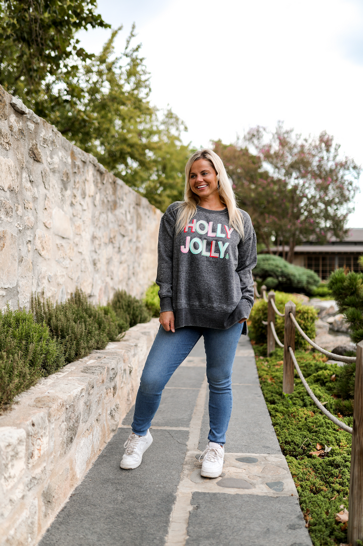 Gray Holly Jolly sweatshirt made of soft fabric, paired with blue jeans, perfect for casual autumn outings.