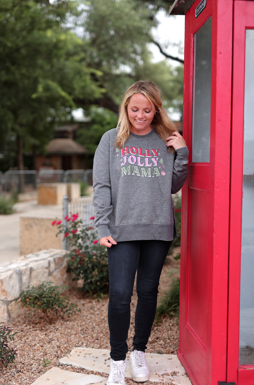 Gray sweatshirt with 'HOLLY JOLLY MAMA' print, cozy and festive, perfect for holiday wear.