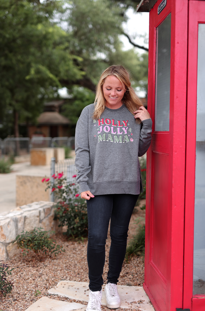 Gray sweatshirt with 'HOLLY JOLLY MAMA' print, cozy and festive, perfect for holiday wear.