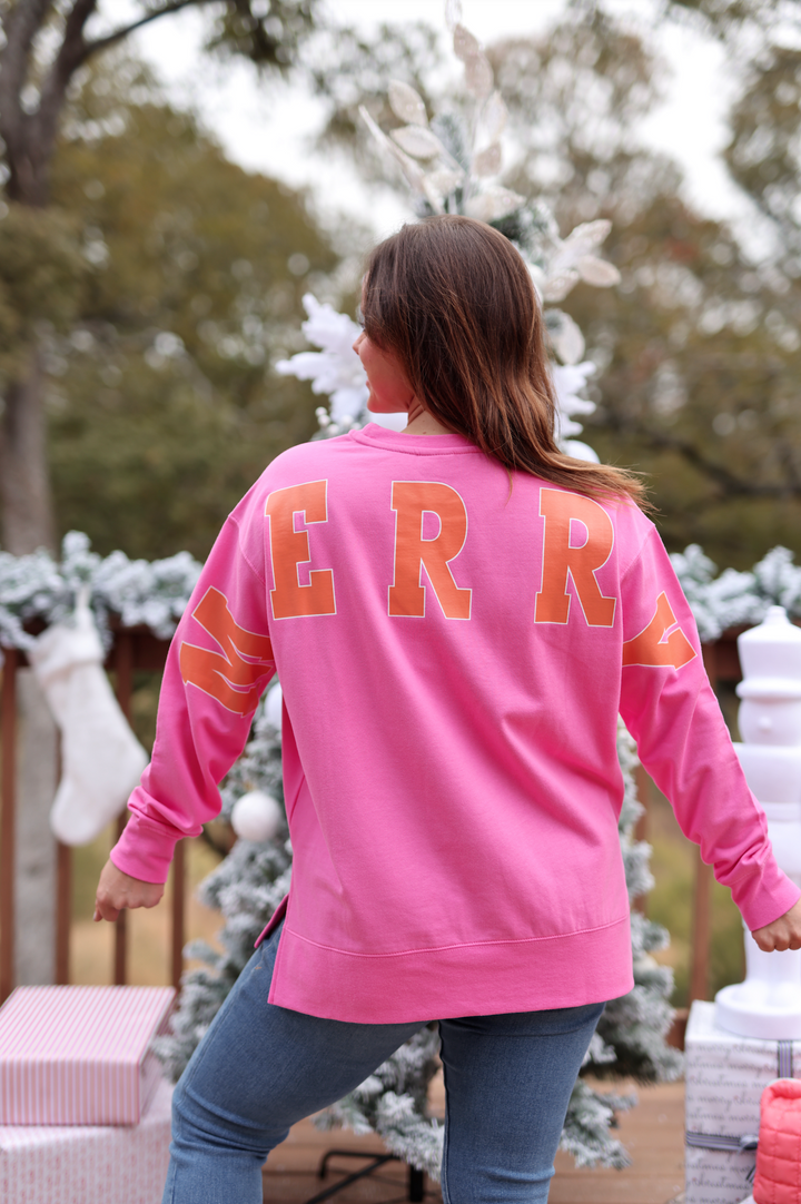 Women's pink sweatshirt with 'MERRY' print, cozy fabric, perfect for holiday season wear.