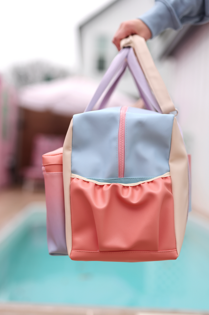 Stylish pastel color tote bag made of durable material, featuring a front pocket and sturdy handles.