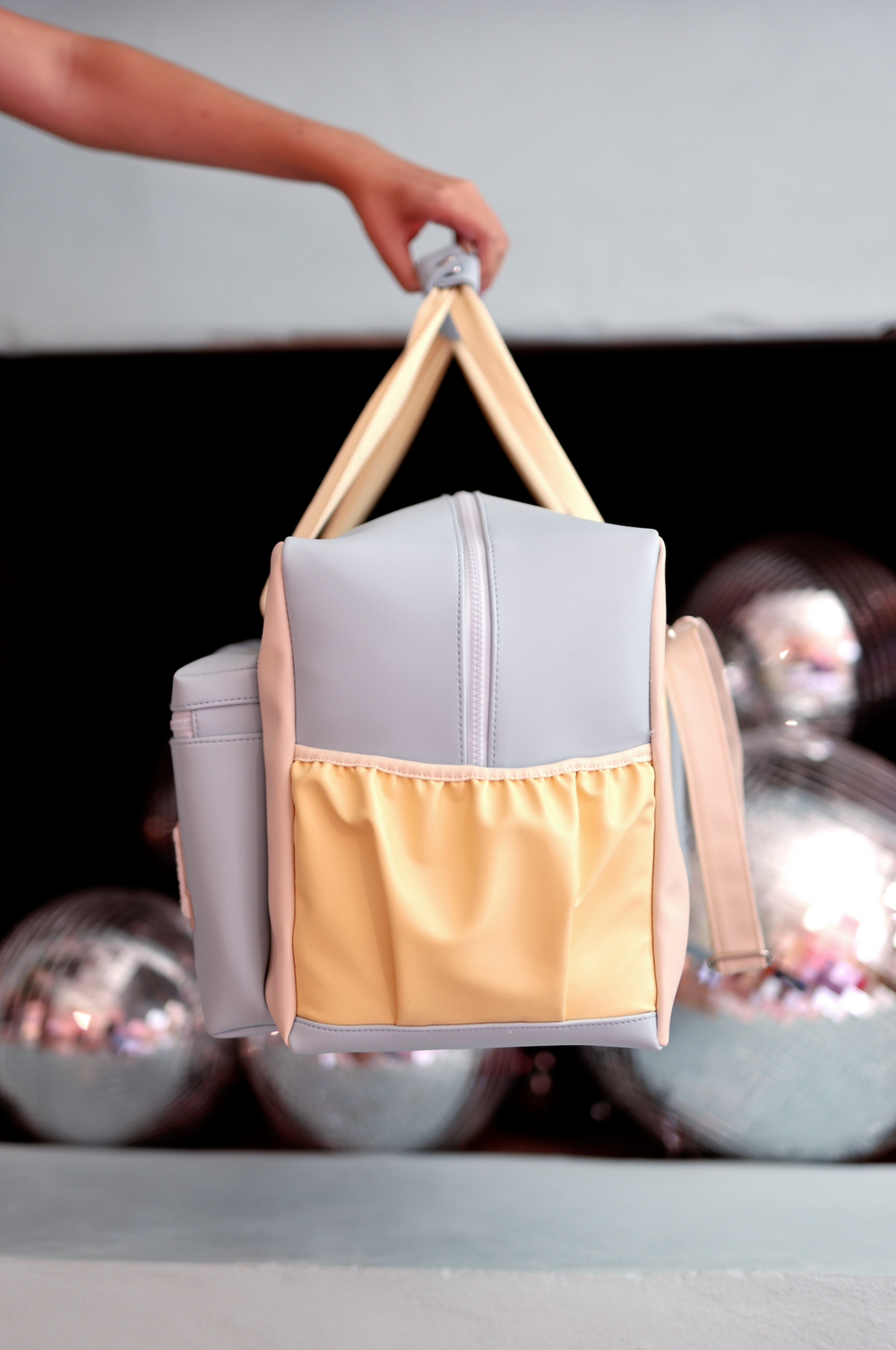 Stylish gray and yellow backpack with spacious pockets, perfect for everyday use.