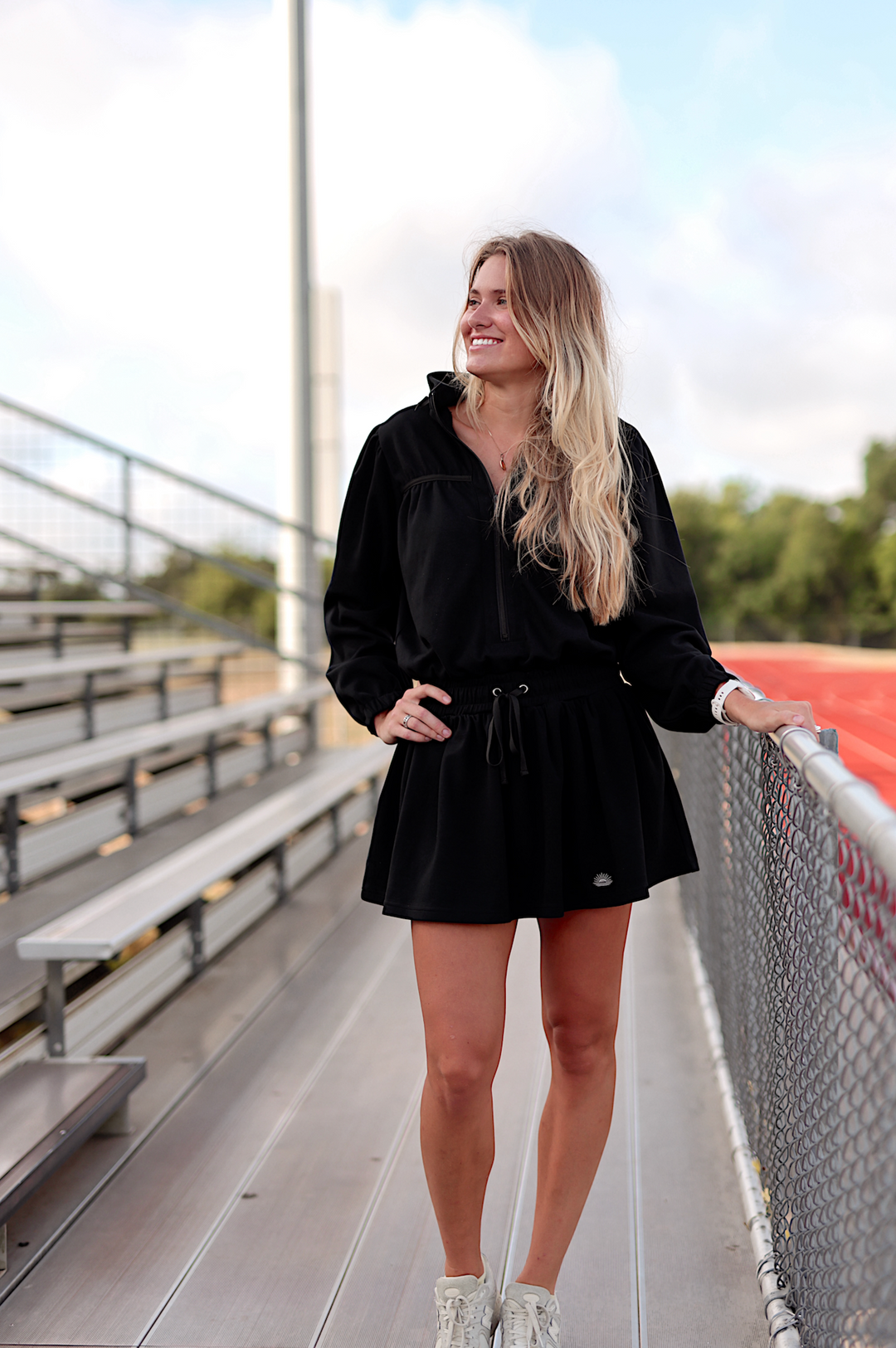 Black hooded dress with drawstring waist, perfect for casual outings or sporty activities.