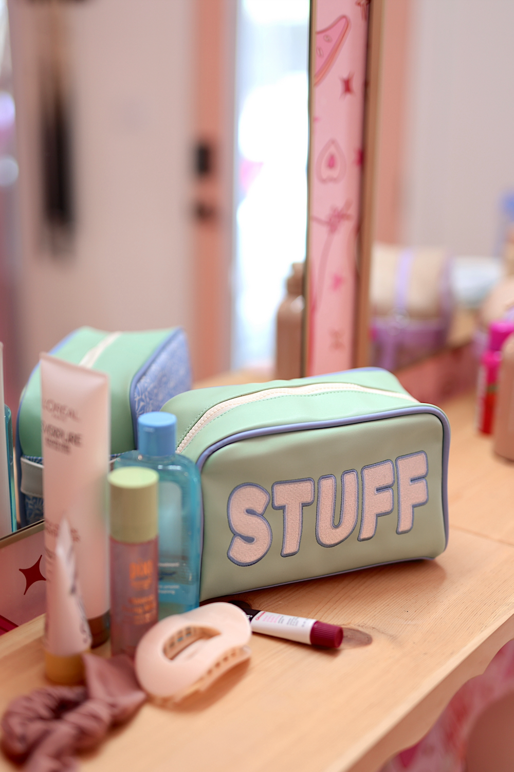 Mint green cosmetic bag with 'STUFF' text, ideal for organizing beauty essentials.