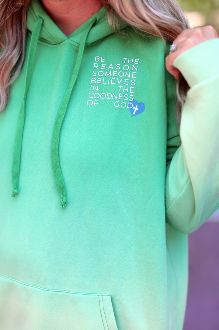 Green hoodie with inspirational text and heart graphic, perfect for casual wear and expressing faith.
