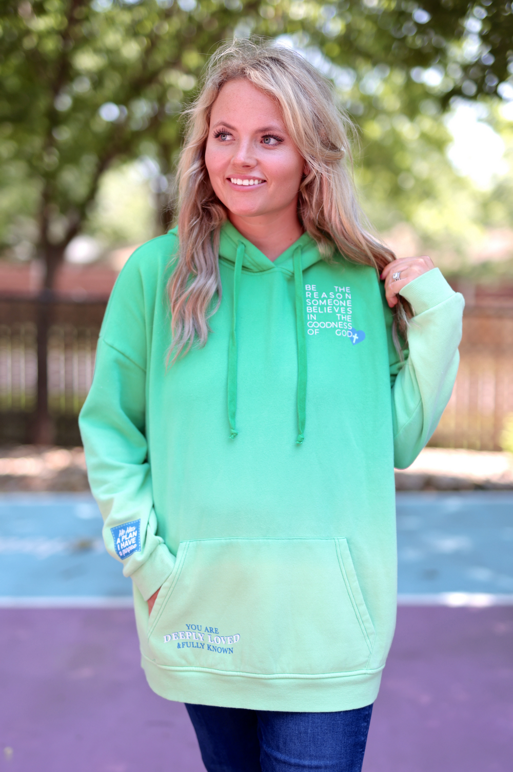 Light green hoodie with inspirational text, featuring kangaroo pocket and adjustable drawstrings.