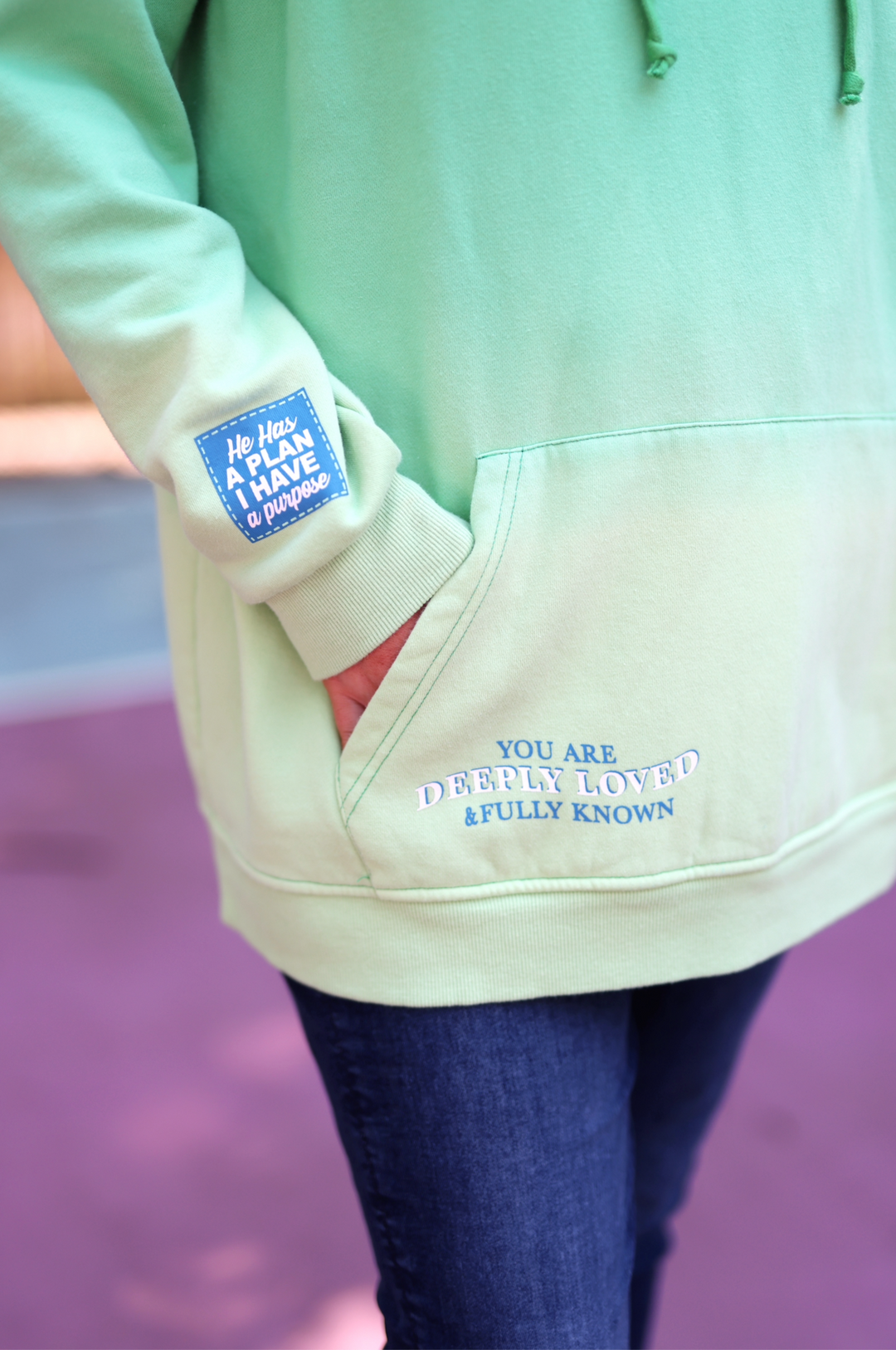 Green ombre hoodie with inspirational quote, soft cotton material, features pocket and cuff design.
