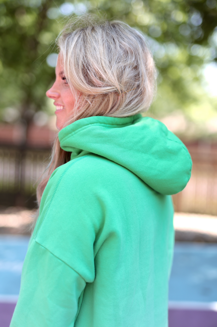 Women's lightweight green hoodie with a cozy hood and soft material, perfect for casual wear.