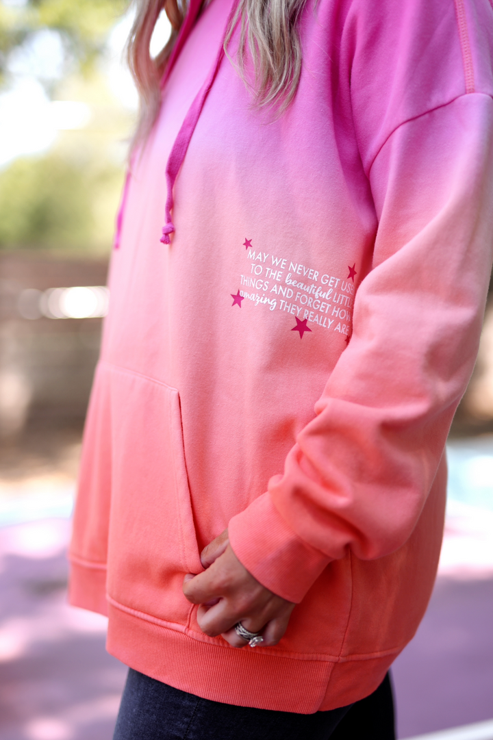 Women’s gradient pink hoodie, cozy cotton blend, featuring motivational quote and front pocket.