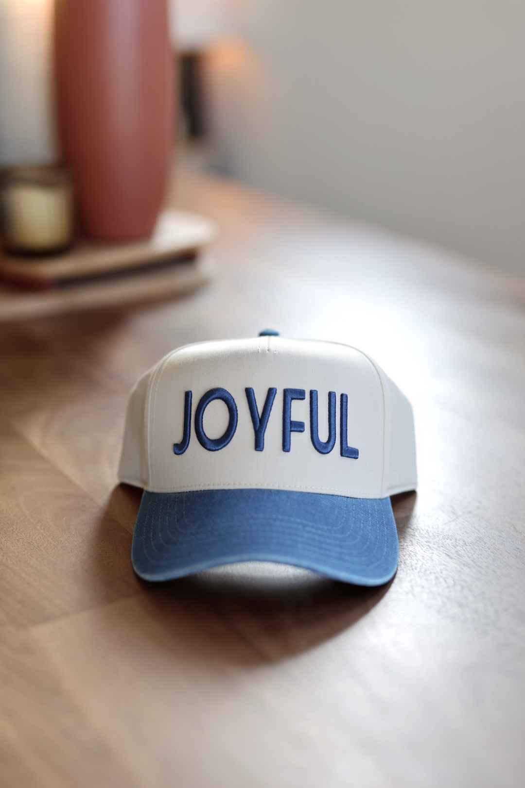 Joyful snapback cap in white and blue, featuring embroidered lettering, perfect for casual wear.