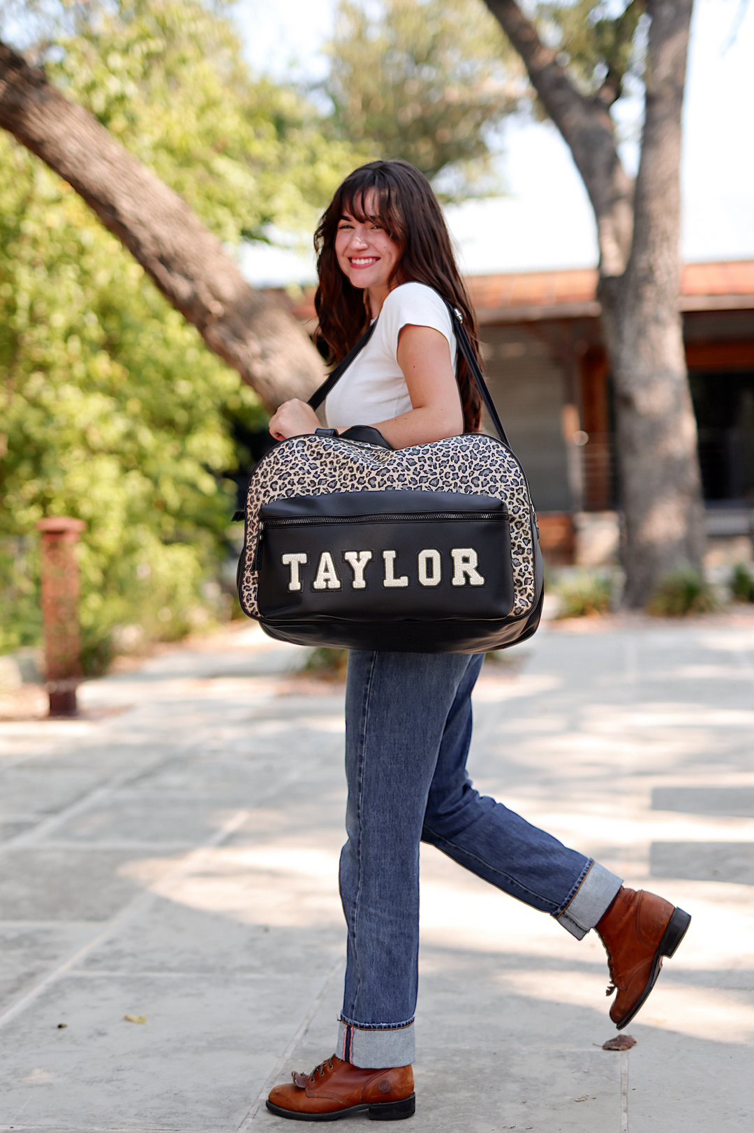 Leopard print duffel bag with custom name 'TAYLOR', durable material, stylish and functional for travel.