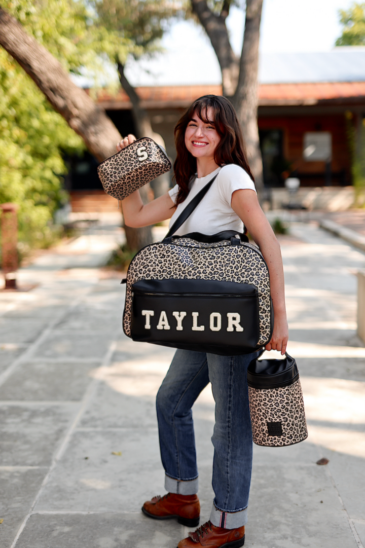 Leopard print tote bag with personalized TAYLOR, accompanied by matching cosmetic case and mini bag.