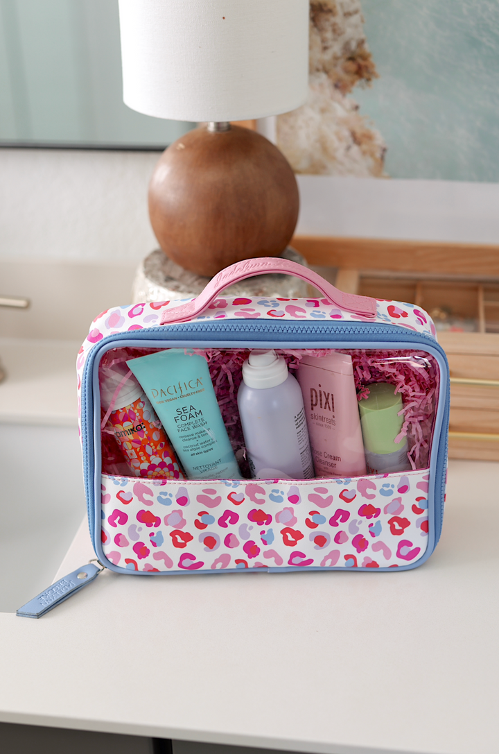 Colorful leopard print cosmetic bag with skincare products inside, perfect for travel and organization.