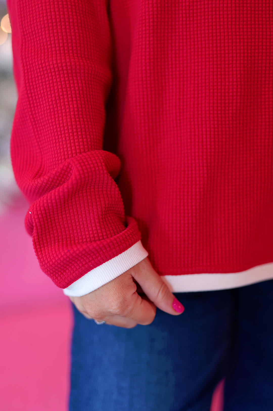 Cozy red waffle knit sweater with white accents, perfect for casual outfits.