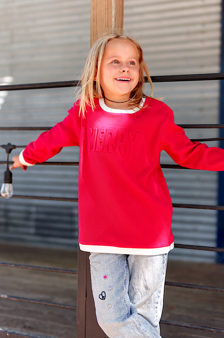 Girls' red long sleeve sweater with 'MERRY' text, made from soft, breathable fabric for casual wear.