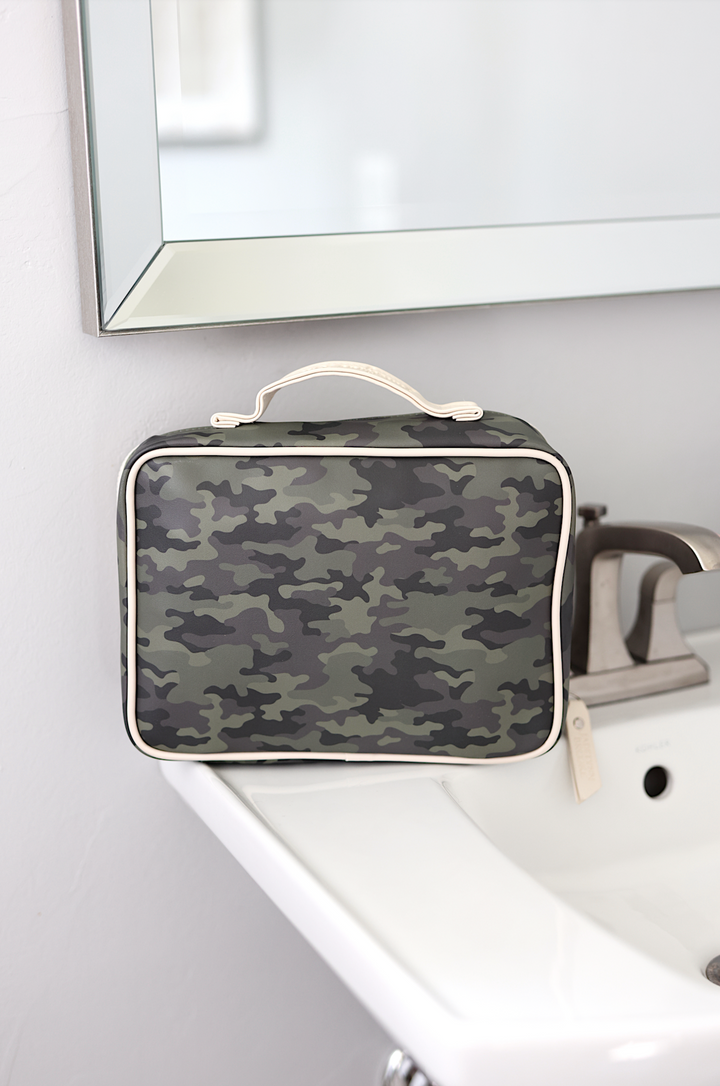 Camouflage travel toiletry bag with cream trim, ideal for organizing personal items.