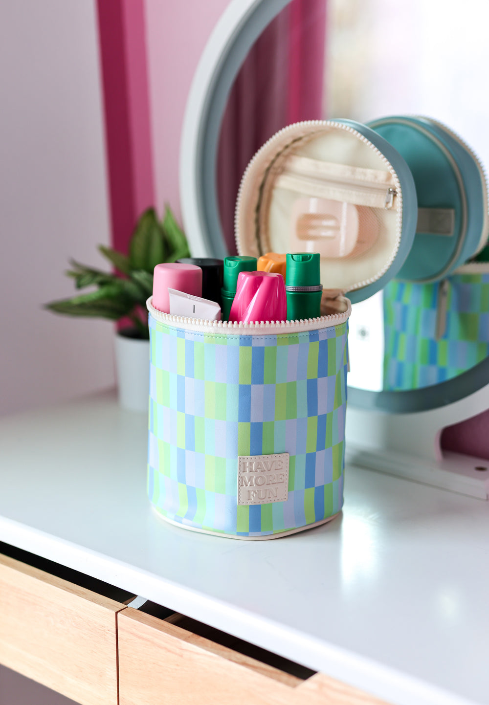 Colorful checkered storage container for pens, featuring pink, green, and blue tones in durable material.