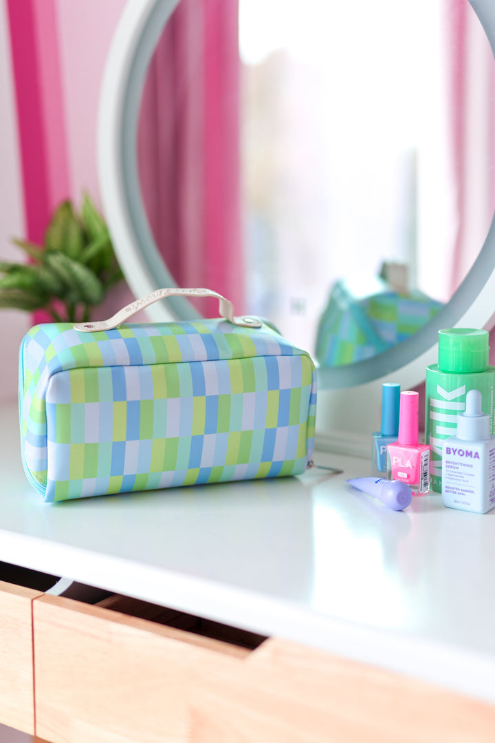 Colorful makeup bag in blue and green checkered pattern, ideal for storing cosmetics and travel essentials.