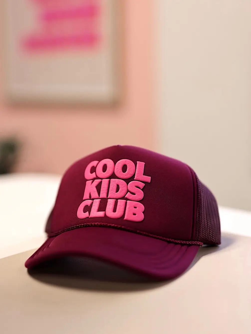 Maroon trucker hat with 'Cool Kids Club' embroidered in pink, perfect for trendy kids.