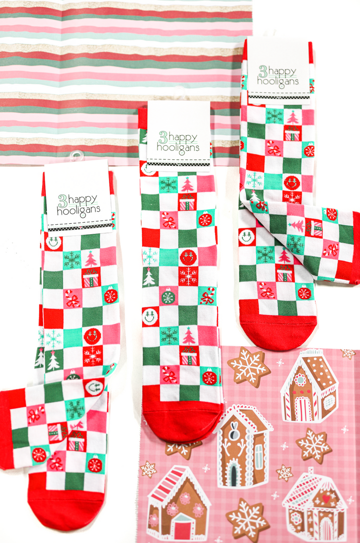 Colorful holiday socks featuring festive patterns in red, green, and white, perfect for Christmas celebrations.