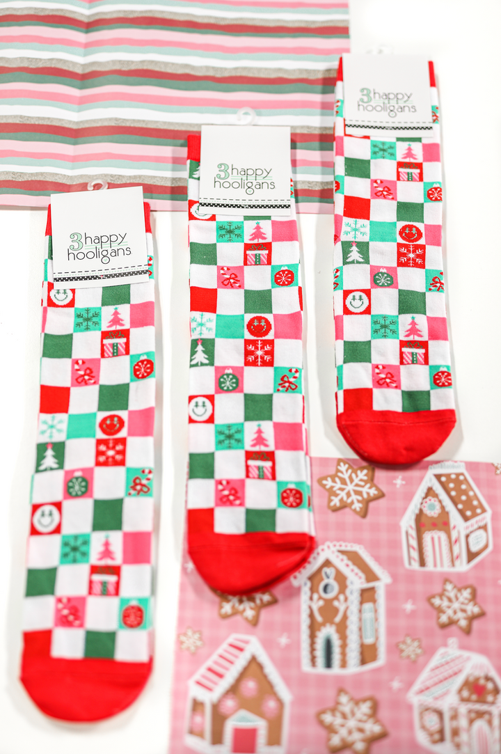Colorful holiday-themed socks set in red, green, and pink, featuring festive patterns by Happy Hooligans.